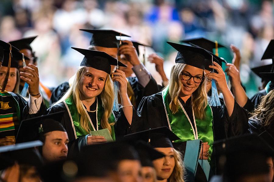 Northwest graduates turn their tassels after the conferral of their degrees on Friday.